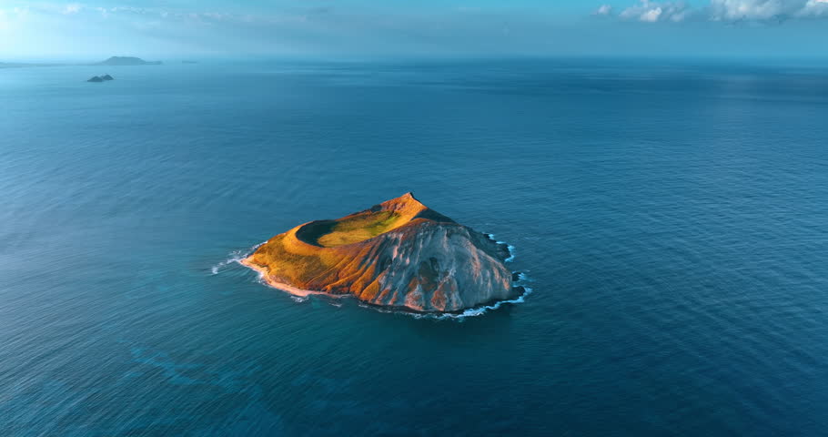 Beautiful bare island surrounded by the Pacific Ocean. Aerial perspective on the Rabbit Island near Oahu, Hawaii, USA.