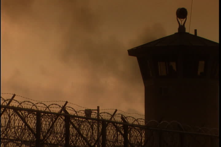 Silhouette of guard tower and barbed wire perimeter fence in morning mist and haze at Southern Ohio Correctional Facility in Lucasville, Ohio. | Shutterstock HD Video #4094608