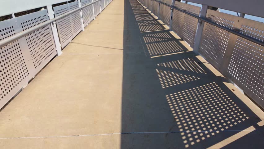 Scenic view of the Rockford Riverwalk crossing a bridge along the Rock River waterfront in Illinois