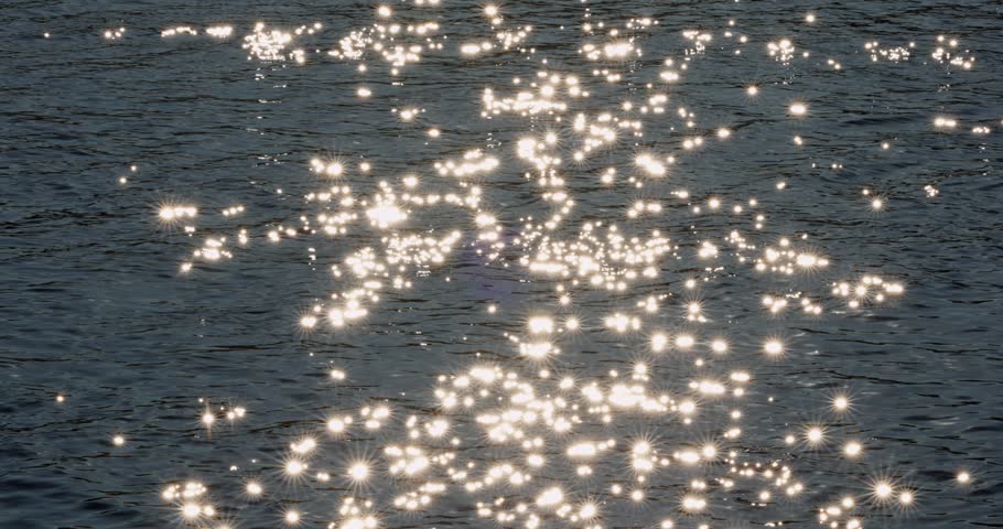 the magical glare of the sun on the surface of the water, Glowing endless calm water surface ripple smooth river at sunset