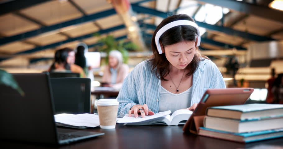 Woman, student and writing with headphones in university study for education, learning or knowledge. Female person, learner or dictionary with sound app for language, audio translation or research