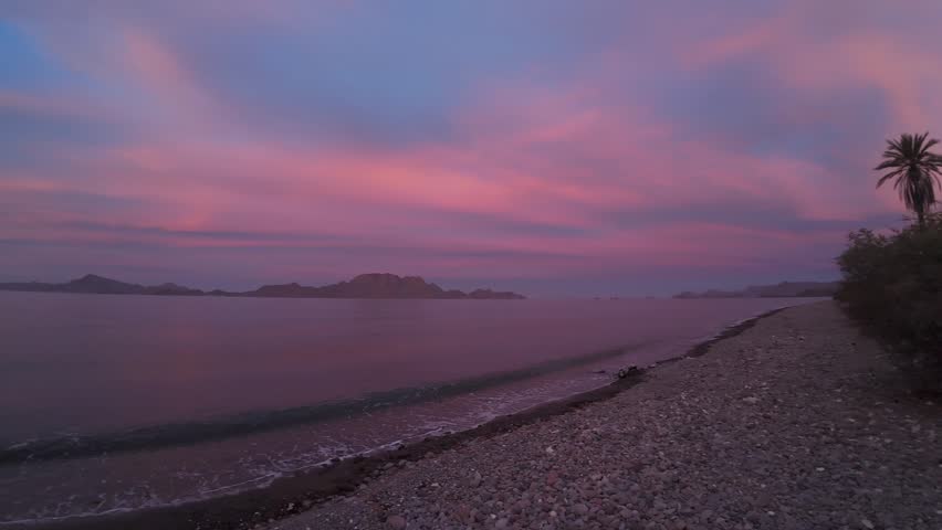 Pink And Purple Sunset Over Calm Sea In Baja California Mexico