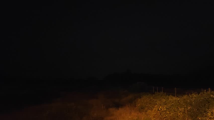 landscape scene of the pitch dark night of the flashing thunderstorm sky.