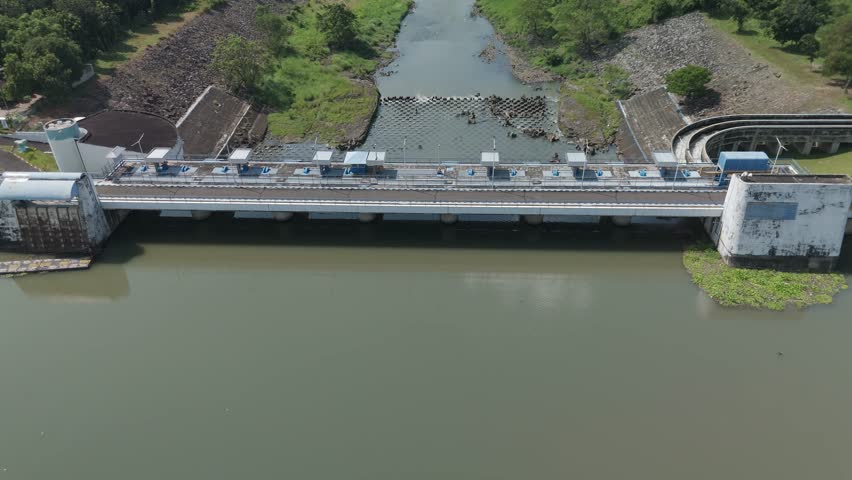 Aerial View of a Modern Dam with Water Channels and Scenic Surroundings Captured from Above
