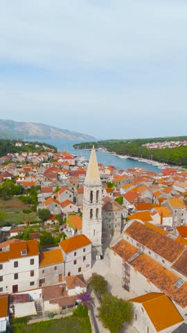 Majestic aerial view of the church of st. Stephen bell tower in stari grad, a historic town on the island of hvar in croatia