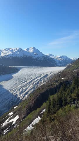 Salmon Glacier flowing through mountains, surrounded by snow and ice in British Columbia, Canada
