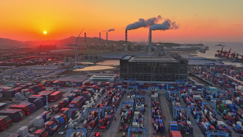 Industrial port area large shipping cargo containers sunset. Fossil fuel power plant air smoke stacks, wind turbine. Global logistics trade industry terminal. Windmill energy factory. Smoking chimneys
