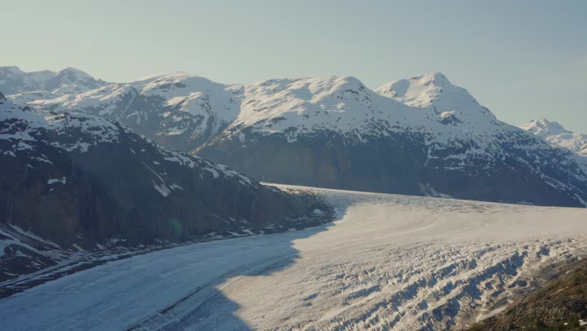 Salmon Glacier flowing through mountains, surrounded by snow and ice in British Columbia, Canada