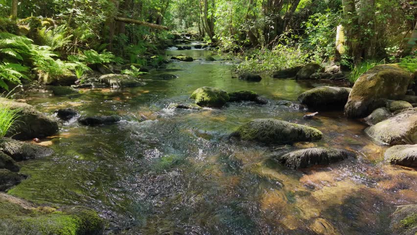 Fast-flowing Streams Of Vaos River Rushing Through Rocks Near Lumeares Bridge In Galicia, Spain. Aerial Pullback Shot