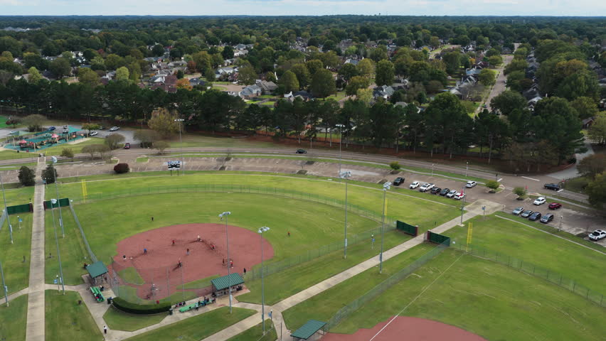 Baseball Players During a Match At Baseball Field In WC Johnson Park In Collierville, Tennessee. aerial orbiting shot