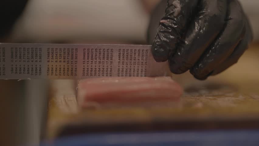 Close-up of measuring meat piece in kitchen