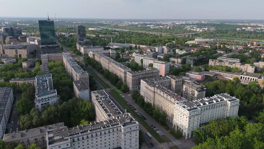 Warsaw: a view of the Intraco skyscraper and the Stawki housing estate as the plane lands, with the modernist buildings on Andersa Street in the foreground, captured during the golden hour on a sunny summer afternoon