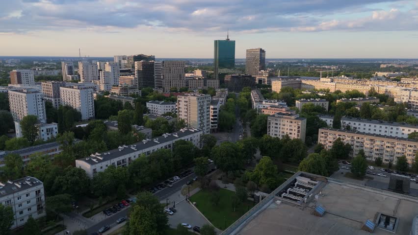 A view of Warsaw, looking towards the old Intraco skyscraper and the Stawki housing estate on a sunny afternoon at golden hour