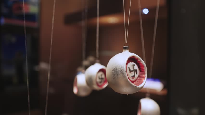 A close-up view of historical swastika-adorned ornaments, part of a World War II exhibit in a museum located in Gdansk, Poland. This display offers a stark reminder of a dark historical period.