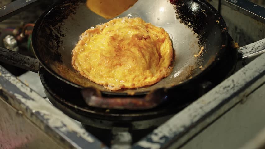 Thai Street Food Omelet Cooking In Wok, Traditional Night Market Food Preparation In Thailand