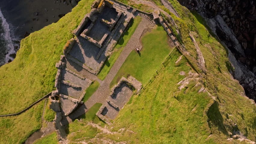 Top down aerial view of the ancient ruins of Tintagel castle in Cornwall during a sunny day
