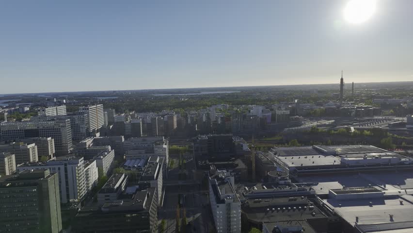 High-resolution aerial view of the Helsinki Exhibition and Convention Centre surrounded by modern city infrastructure, transportation networks and commercial buildings. Major business and event venue in the Finnish capital.