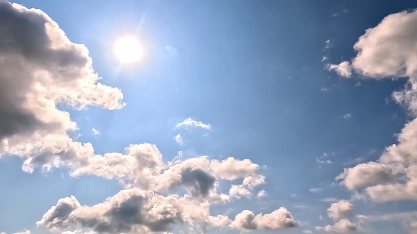 Fast flowing of dramatic clouds in the Daylight Skies. 4K video (Ultra High Definition) of cloudscape and bright sun. Sky and clouds Timelapse. Sun shines through the clouds on the blue sky background. 