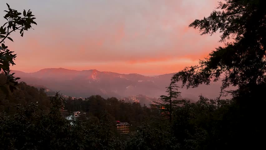 dramatic sunset over mountain ranges featuring vibrant clouds and scenic horizon at dusk