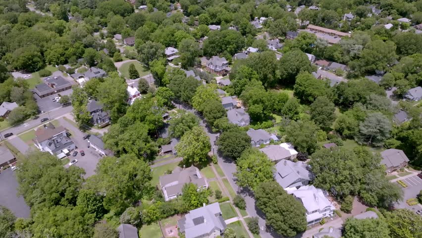 Neighborhood homes in Statesville, North Carolina with drone video moving forward.