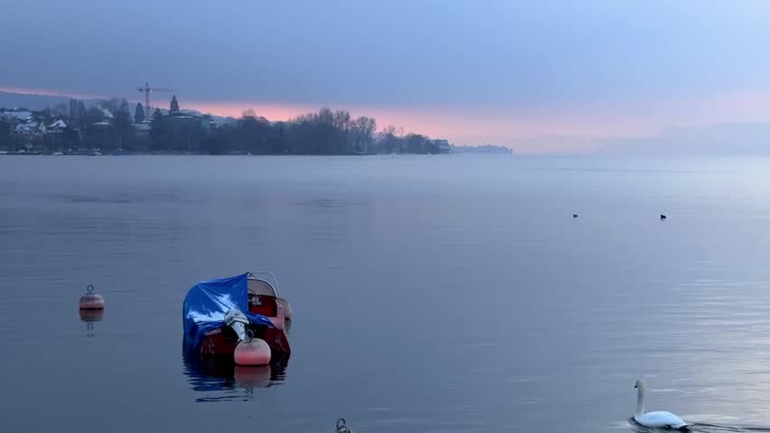 A misty morning on Zurich lake at dawn. 