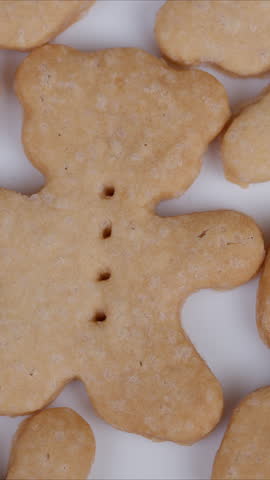 Homemade bearshaped cookies displayed artistically. Closeup of crafted bear cookies on white surface. Detailed view of homemade bear cookies with perforated details