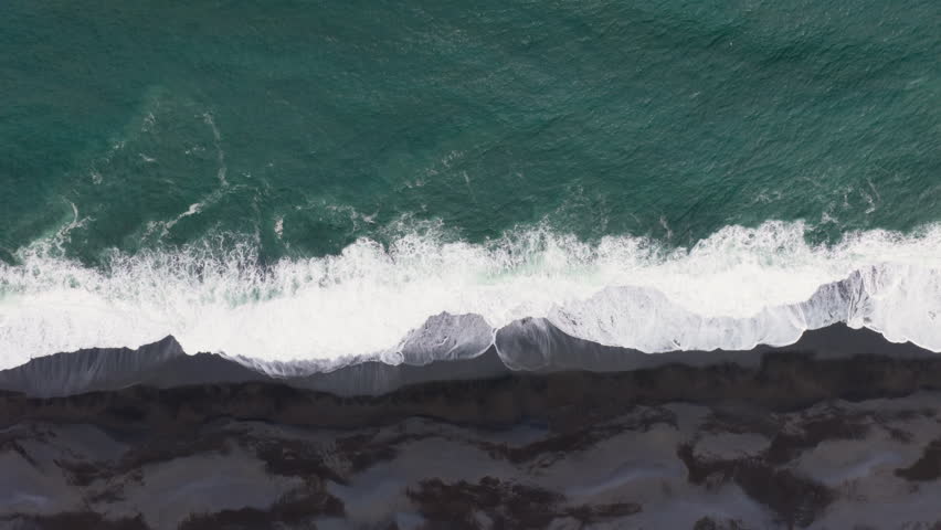 Aerial view of ocean crashing on the beach. black sand. Iceland