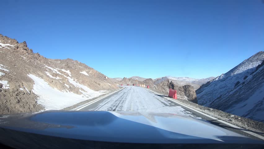 Driving off road car in high altitude mountains in Tibet, China	