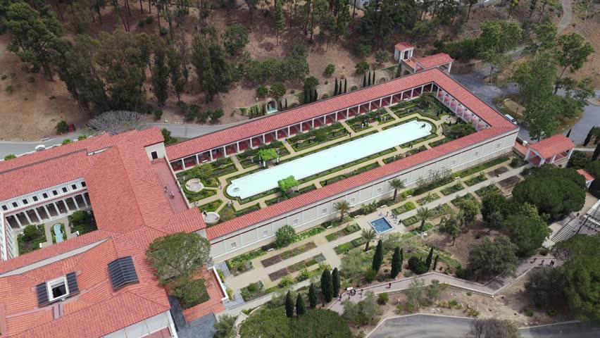 Elegant Villa museum in Malibu, California featuring Roman architecture, lush gardens, reflecting pool and coastline landscape in Los Angeles County