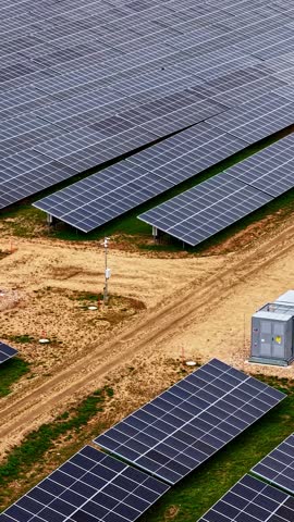 Large solar panel array in a field with dirt roads.