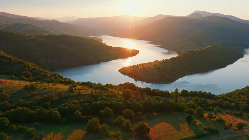 Kardzhali reservoir bend canyon landscape sunset golden hour light over hills green mountains valley water reflection panoramic aerial drone view travel Bulgaria