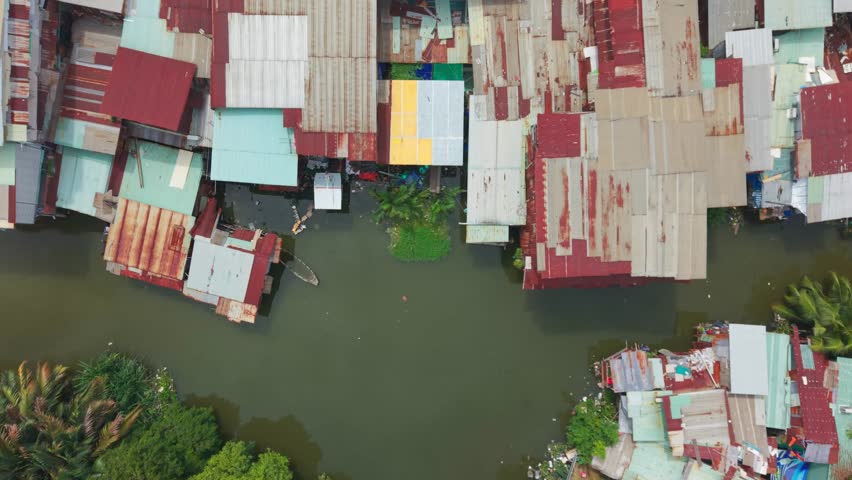 Drone top view of houses along water canal in urban area of Saigon Vietnam