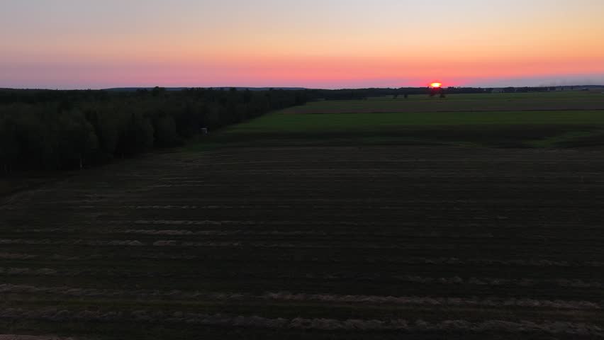 Spectacular sunset over Lake Huron in Hessel, Michigan with aerial drone view.