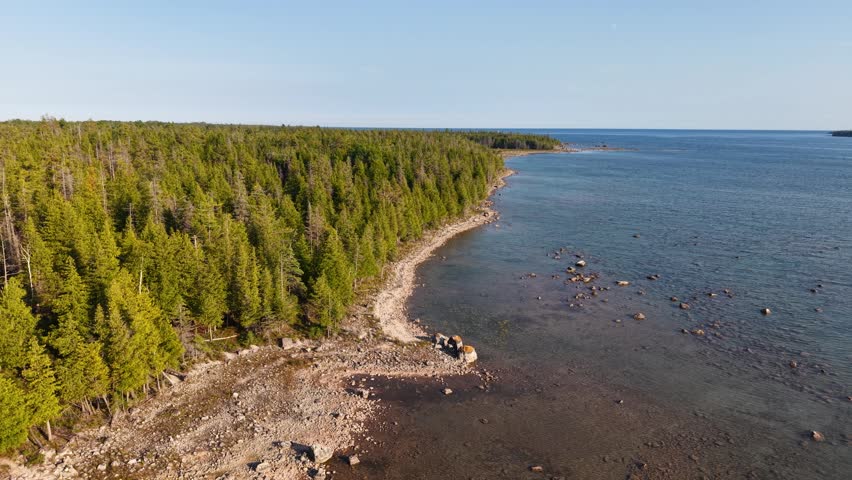 Drone shot of a serene shoreline at Hessel with Lake Huron in the background.
