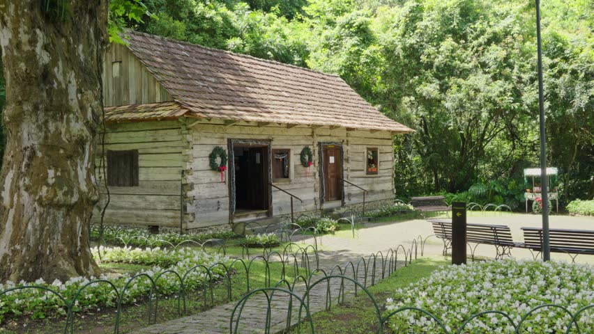 Historic wooden house in a lush park, depicting vintage architecture and serene environment