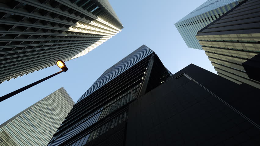 Modern Tokyo skyscrapers with a street lamp in the lower foreground.