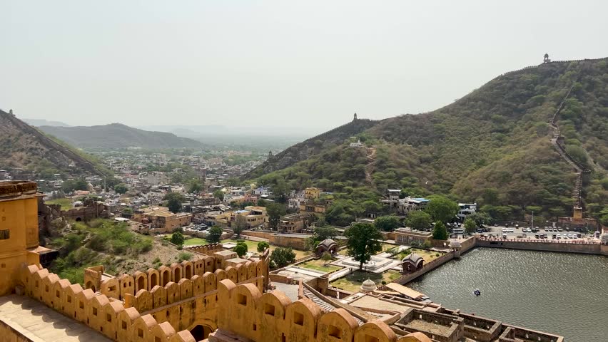 Scenic view of Amer Fort with Maota Lake in the foreground, surrounded by the Aravalli hills in Jaipur, Rajasthan, India.