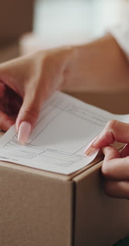 Hands, box and writing on shipping label for package delivery, tracking code and logistics process. Small business owner, woman and parcel sticker for distribution notes, address info or supply chain