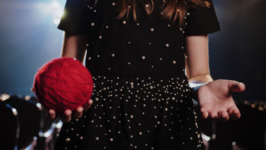 Dressmaker Throwing Red Yarn Ball Up. Fashion Design Concept