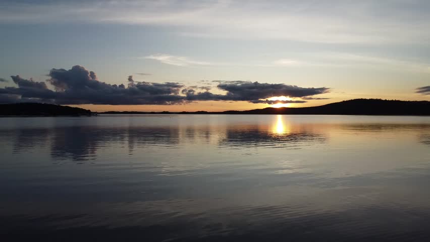 Sunset over calm Swedish lake