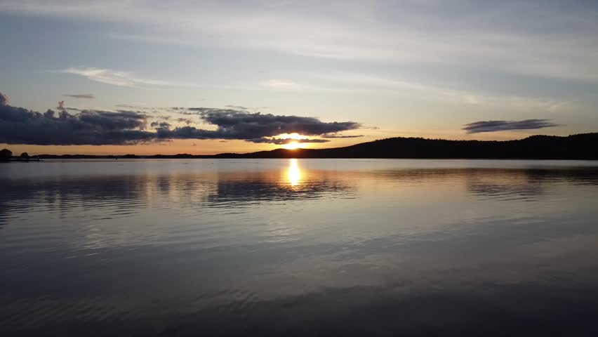 Sunset over calm Swedish lake during Fall