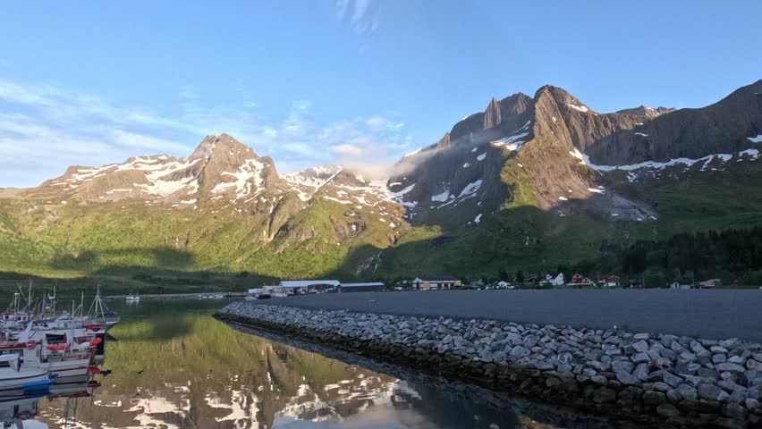 Cloud play in a small Norwegian harbor under high hills