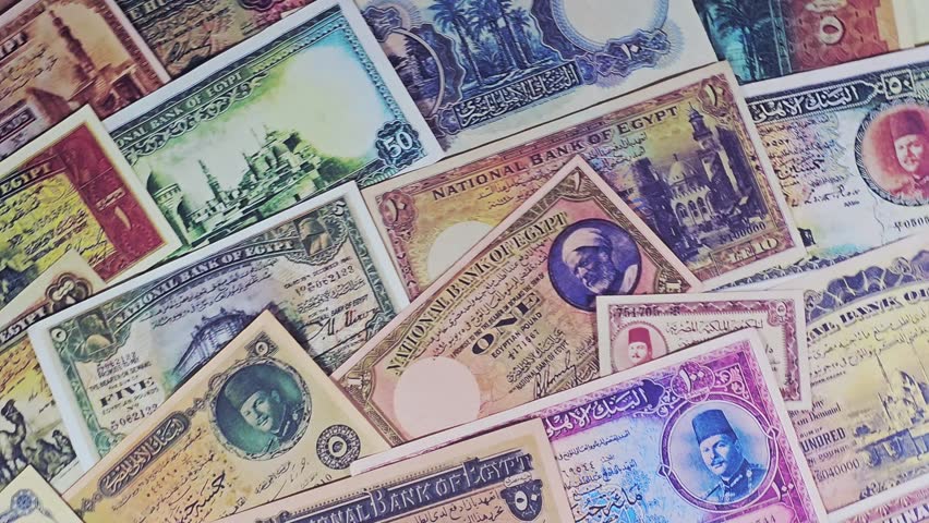 Top view of a collection of rare, vintage Egyptian banknotes, from the late 19th and early 20th centuries, old vintage retro Egyptian cash money banknotes at the era of the kingdom of Egypt and Sudan