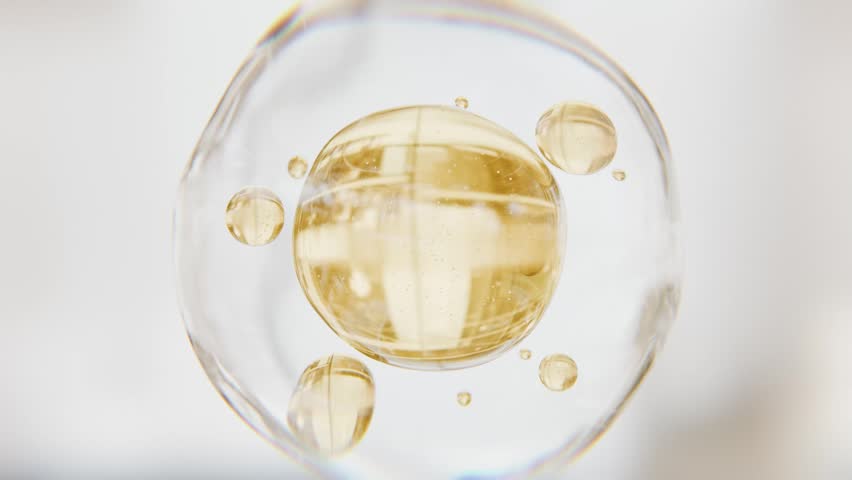 Golden serum liquid bubbles. Luxury beauty cosmetics macro 3D abstract background. Bio moisturizer essence gel or oil drops. Collagen fluid molecule. Moisturizing peptide face cream for skin lifting