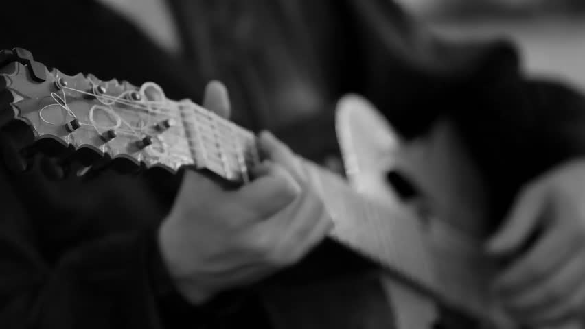 Black and white close up of acoustic guitar fingerstyle playing technique