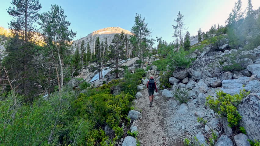 Man Backpacks Uphills in Yosemite National Park