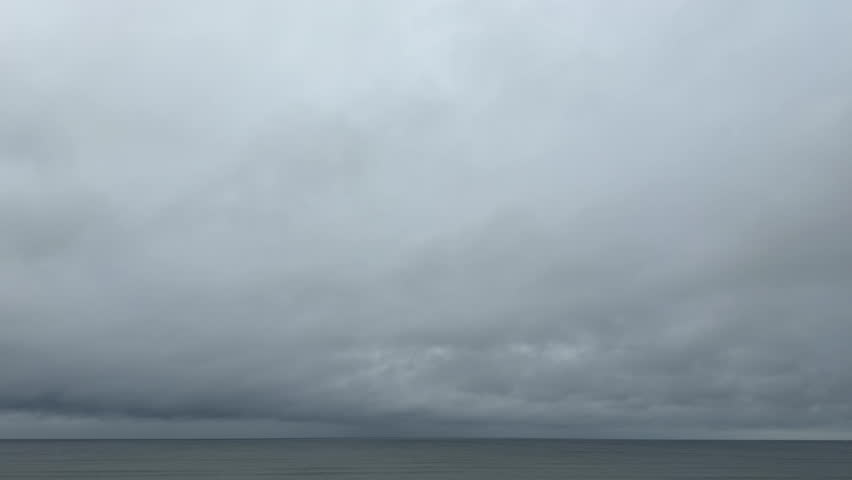 Calm Sea Beneath Heavy Overcast Clouds