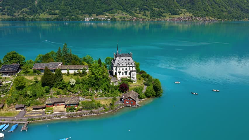 Aerial view of the beautiful Seeburg castle on the Iseltwald peninsula in lake Brienz, Switzerland.