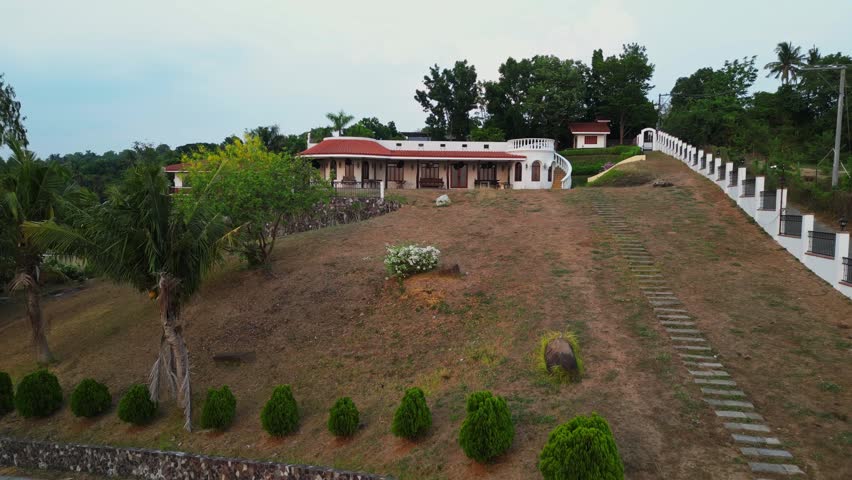 Static atmospheric aerial frame of Casa Miranda wedding venue in Gonzales Tanauan City Batangas Philippines with warm golden hour light and tropical greenery.