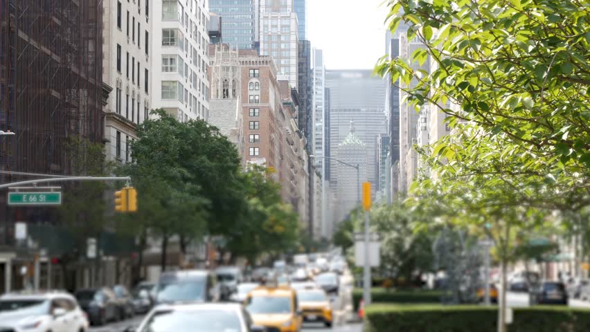 Manhattan Midtown East straight street, Park avenue New York City Turtle bay, United States. Yellow taxi car, urban road traffic. Summer green trees on boulevard. Transport and greenery in East Side.